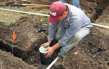 Danville sprinkler repair specialist installs a new valve station in housing