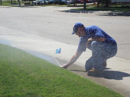 Danville CA irrigation repair contractor adjusts a Rain Bird pop up sprinkler head