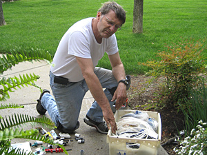 Alamo sprinkler repair man adjust a nozzle